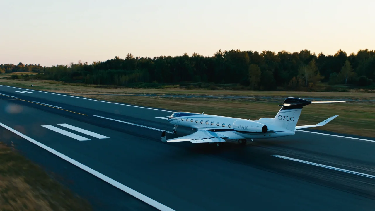 Gulfstream G700 on a runway at dusk